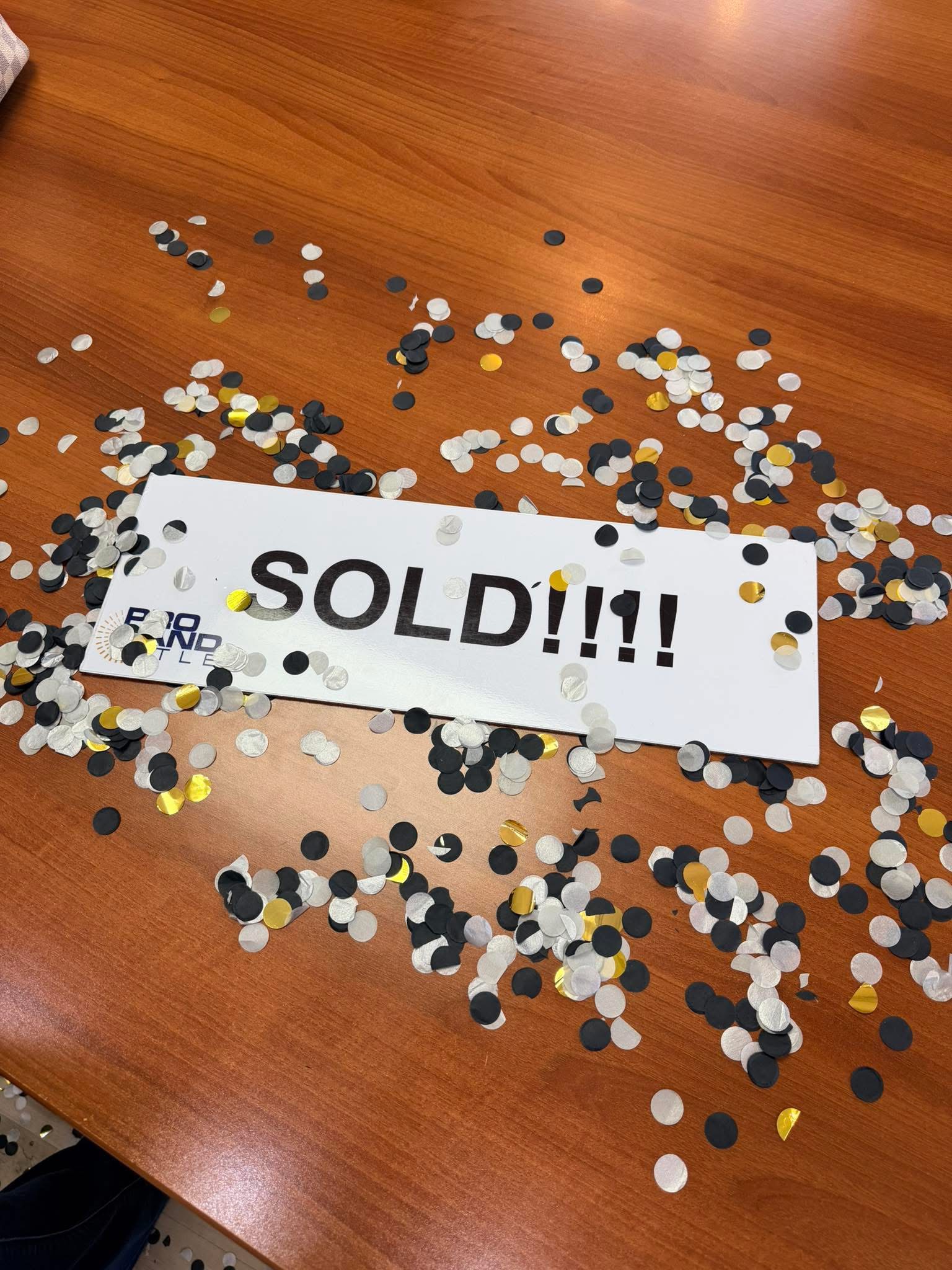 Sold sign surrounded by closing day confetti
