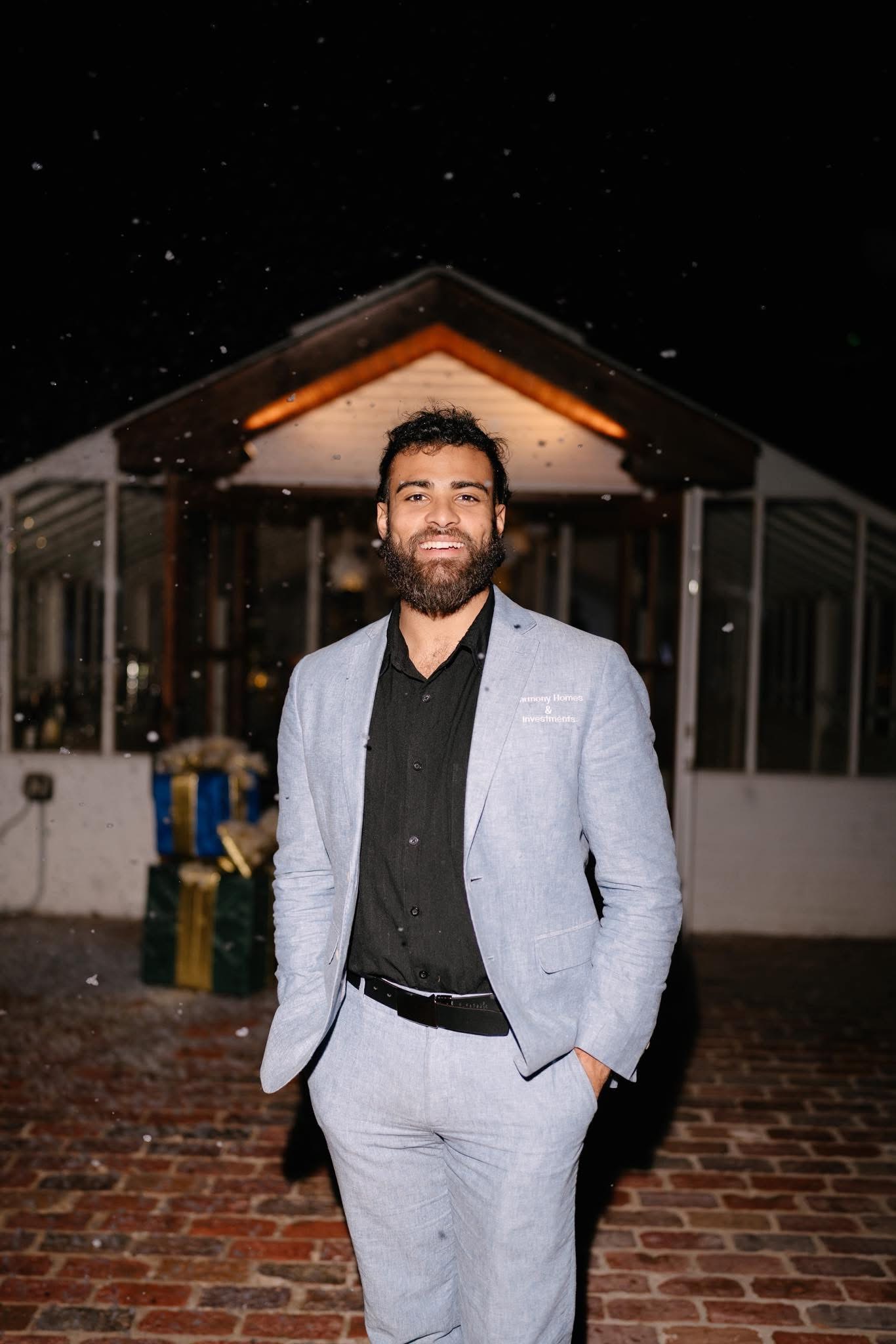 Madison Burke in a gray suit outside at night